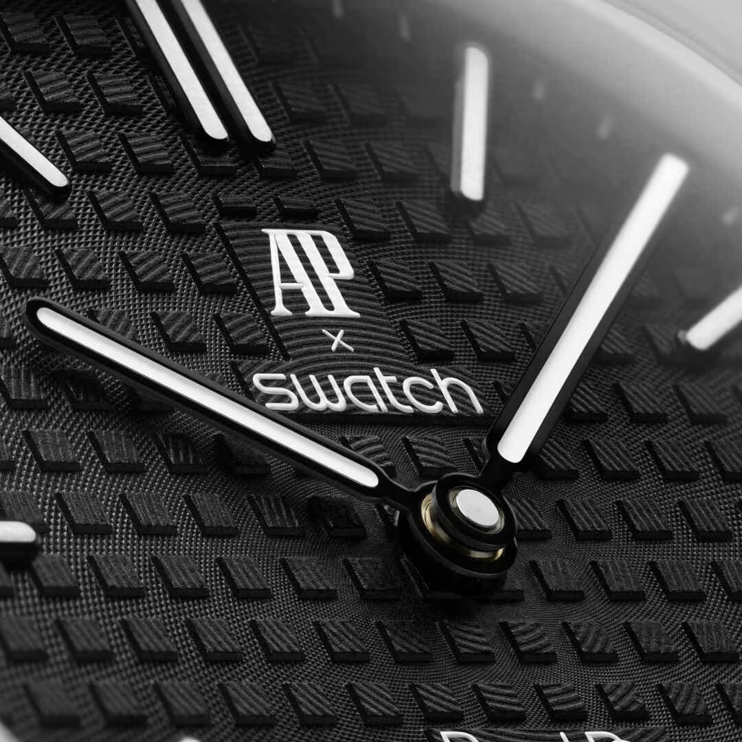 inkspireluxury mechanical watch dial featuring a black grid pattern with white hands and collaborative branding
